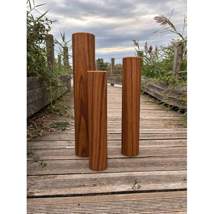 8-minute Rain Pillar with rosewood finish in an outdoor setting on a wooden walkway